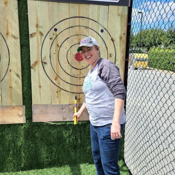 a man standing in front of a fence