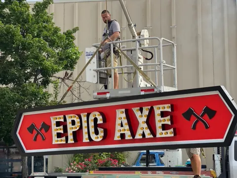 a truck that has a sign on the side of a building
