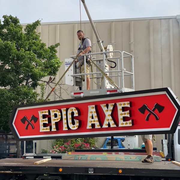 a truck that has a sign on the side of a building
